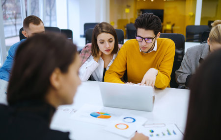 Group of young businesspeople working together in creative office. Planning, analysis, collaboration.の写真素材