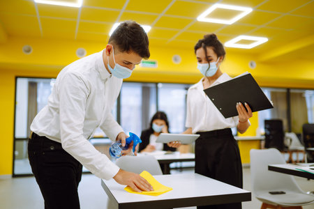 Business team people in protective face mask brainstorm on corporate project together write strategyの写真素材