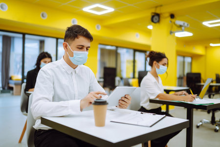 Business team people in protective face mask brainstorm on corporate project together write strategyの写真素材