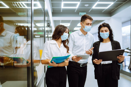 Business team people in protective face mask brainstorm on corporate project together write strategyの写真素材
