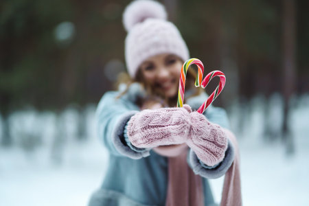 Christmas wreath in beautiful woman hands in snow forest. seasonal holidays, adorning. Christmas.の写真素材