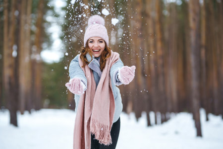 Christmas wreath in beautiful woman hands in snow forest. seasonal holidays, adorning. Christmas.の写真素材