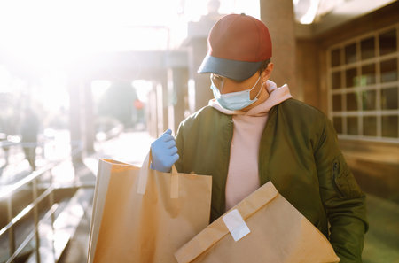 Courier delivers a bag of food in quarantine city. delivery service concept. Covid-2019.