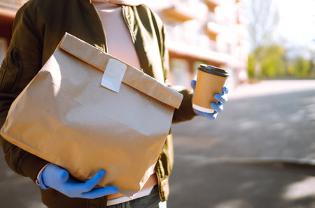 Courier delivers a bag of food in quarantine city. delivery service concept. Covid-2019.の写真素材