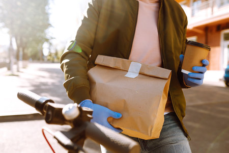 Courier delivers a bag of food in quarantine city. delivery service concept. Covid-2019.の写真素材
