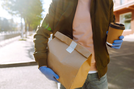 Courier delivers a bag of food in quarantine city. delivery service concept. Covid-2019.