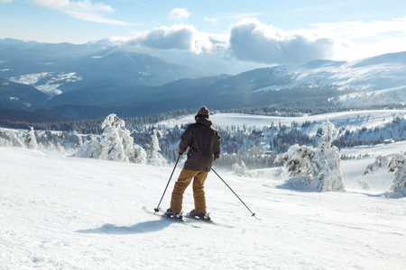 Man skiing in the mountains. Skiing in the snowy mountains, Winter is coming, snowfall. active lifestyle.の写真素材