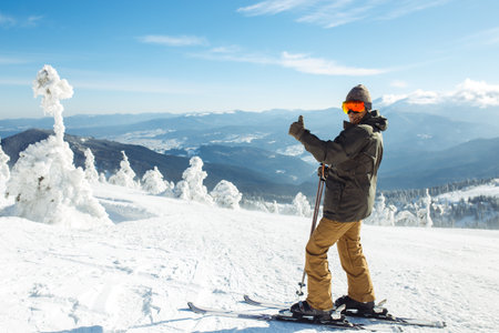 Man skiing in the mountains. Skiing in the snowy mountains, Winter is coming, snowfall. active lifestyle.の写真素材