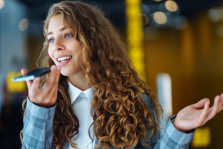 Young woman sitting with a book, laptop in the library and taking learning notes. concept of education.の写真素材
