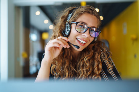 meeting online. Young woman wearing headphones using laptop watching webinar or doing video chat.の写真素材
