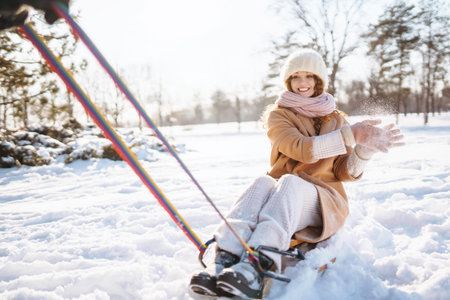 Happy woman walking in the snowy winter day outdoor. Winter fashion, holidays, rest, travel concept.の写真素材