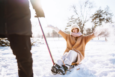 Happy woman walking in the snowy winter day outdoor. Winter fashion, holidays, rest, travel concept.の写真素材