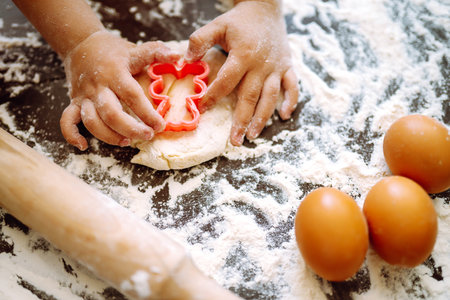 Children hands kneading dough for baking. Kids hands, some flour, wheat dough. Cookies for Christmas.の写真素材