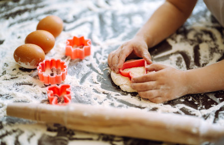Children hands kneading dough for baking. Kids hands, some flour, wheat dough. Cookies for Christmas.の写真素材
