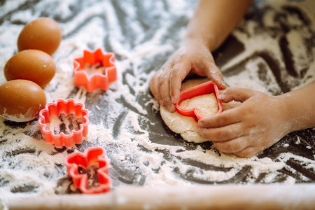 Children hands kneading dough for baking. Kids hands, some flour, wheat dough. Cookies for Christmas.の写真素材