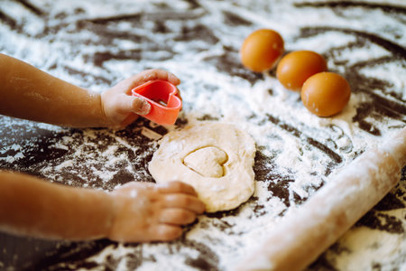 Children hands kneading dough for baking. Kids hands, some flour, wheat dough. Cookies for Christmas.の写真素材