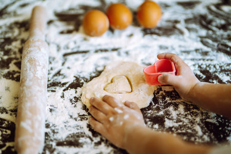 Children hands kneading dough for baking. Kids hands, some flour, wheat dough. Cookies for Christmas.の写真素材