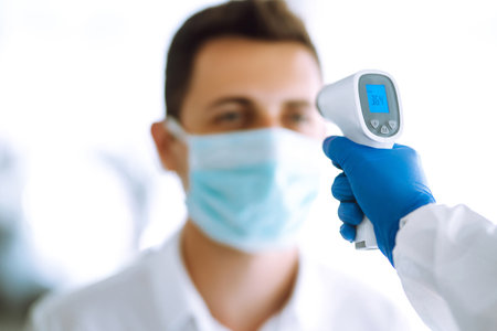 checking the temperature of office workers during   pandemic.の写真素材