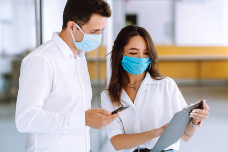 Office worker with face mask working office. The concept of preventing the spread of the epidemic.の写真素材