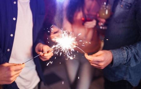 New year glasses for champagne in the hands of friends. Christmas New Year's toast.の写真素材