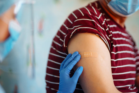 Close up photo of senior patient arm with doctor`s hands making injection.
