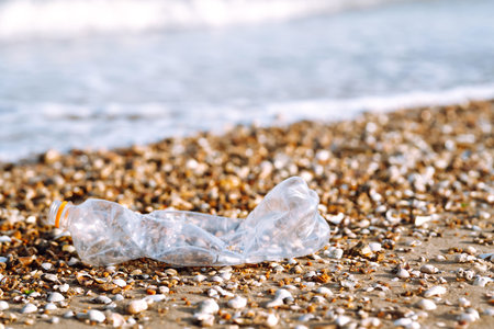 Empty plastic bottles on the beach,. Trash on the beach. Seashore and water pollution concept.