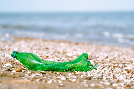 Empty plastic bottles on the beach,. Trash on the beach. Seashore and water pollution concept.の写真素材