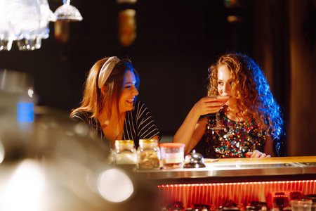 cocktail party. ?ocktail in the hands of a woman. Young woman drinking cocktails in bar.