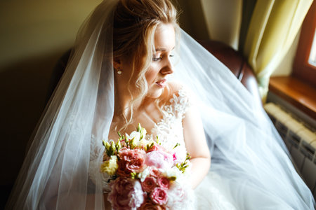 Gorgeous beauty young bride portrait. Morning of the bride. Beautiful bride in white wedding dress.の写真素材