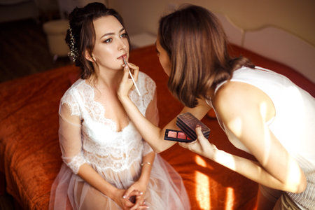 Elegant young bride portrait. Morning of the bride. Beautiful bride in white wedding dress.の写真素材