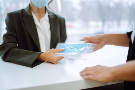 A female doctor in visor and protective gloves discussing an x-ray. Doctor examines an X-ray.の写真素材