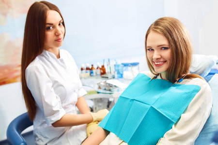 Overview of dental caries prevention. Woman at the dentist's chair during a dental procedure. Healthy Smile.の写真素材