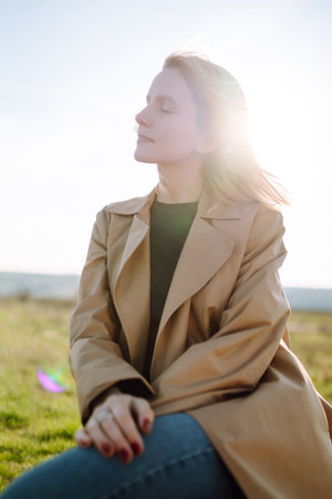 Young woman enjoys a spring sunny day. People, lifestyle, travel, nature and vacations concept.の写真素材