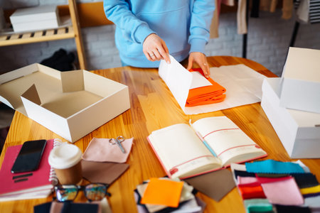 Close-up of preparing a parcel on the table. Woman online store, small business owner, entrepreneur.の写真素材
