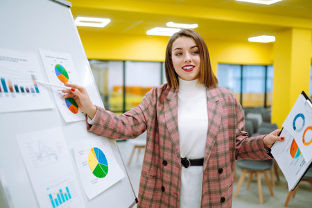 Young woman leader, presenter, make a business presentation at a conference in the office.