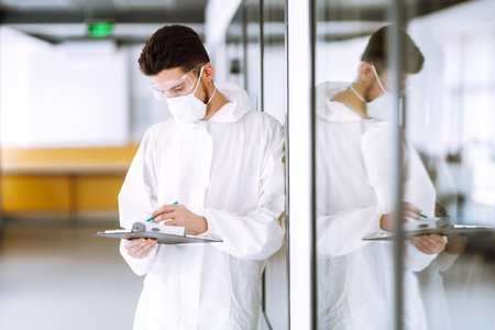 Disease control expert with an Infrared thermometer equipment to check the temperature.