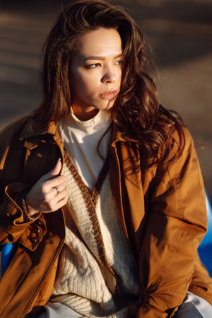 Stylish woman enjoying autumn weather outdoor. Fashion, style concept. People, lifestyle, relaxationの写真素材