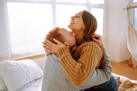 Couple in love relaxing at home on bed while they hug each other. Valentine's Day, holiday concept.の写真素材