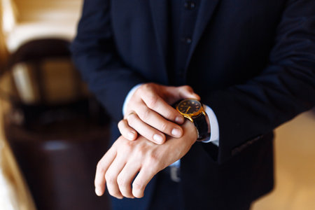 Stylish men's wrist watch, the man is watching the time. Businessman clock, businessman checking...