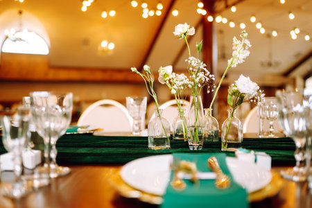 Floral decorations on the banquet table in the restaurant. Wedding, birthday, party, event concept.