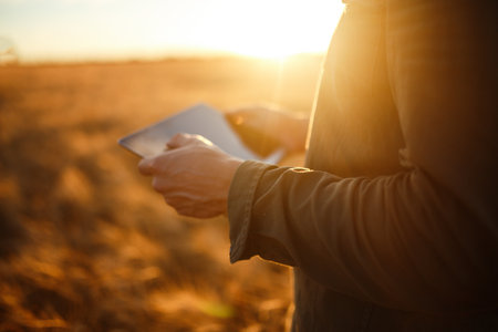 Amazing photo of Farmer. Checking Wheat Field Progress, Holding Tablet Using Internet.の写真素材
