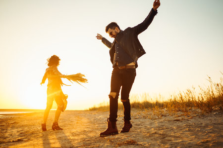 enjoying time together. Stylish and loving couple enjoying each other by the sea.の写真素材