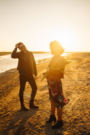 enjoying time together. Stylish and loving couple enjoying each other by the sea.の写真素材