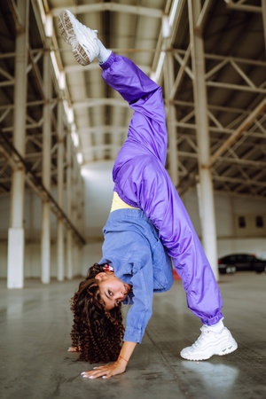 Beautiful sportive girl dancing in stylish clothes in the underpass. Sport,dancing and urban culture
