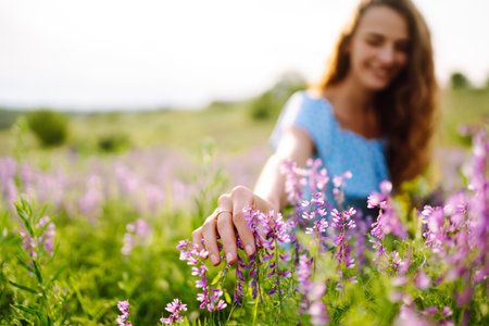 Portrait of beautiful woman in amazing in a blooming field. Nature, vacation, relax and lifestyle.の写真素材