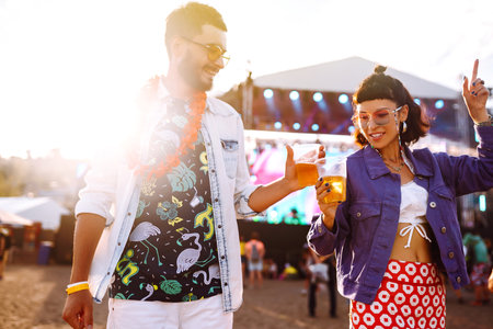 Couple with beer at music festival. Summer Beach party, holiday, vacation concept.の写真素材