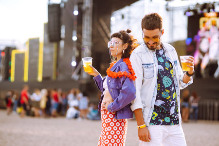 Couple with beer at music festival. Summer Beach party, holiday, vacation concept.の写真素材