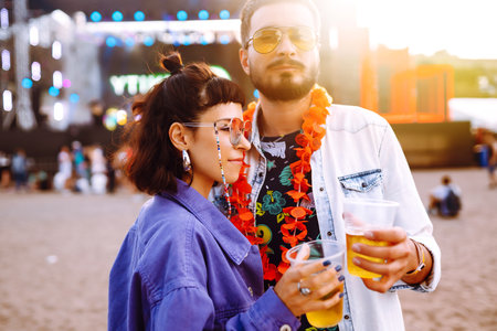 Couple with beer at music festival. Summer Beach party, holiday, vacation concept.の写真素材