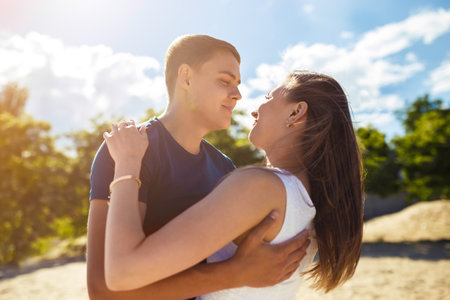Couple in love enjoying tender moments during sunset. Emotional concept of relationship.の写真素材