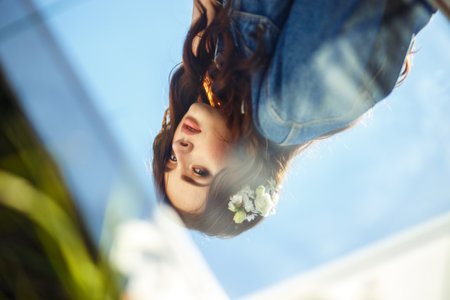 Portrait of a beautiful bride through mirror. wedding concept. Stylish wedding. Great sunset light.の写真素材